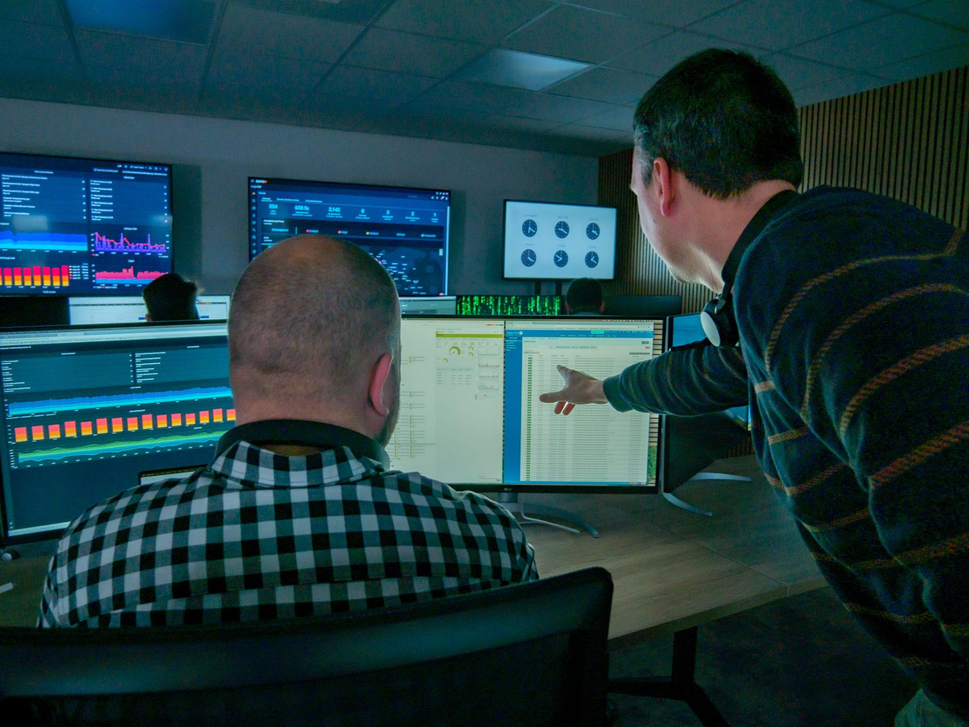 Two engineers working together in the Security Operations Room