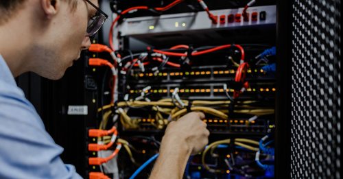 Engineer fixing cables datacenter